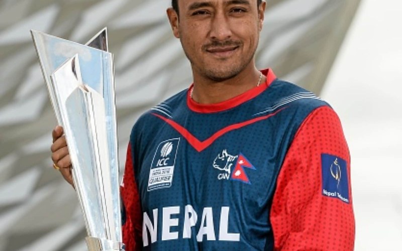 Paras Khadka in a Nepal jersey holding a trophy. Photo: Cricfit / Wikimedia Commons (CC BY-SA 4.0)