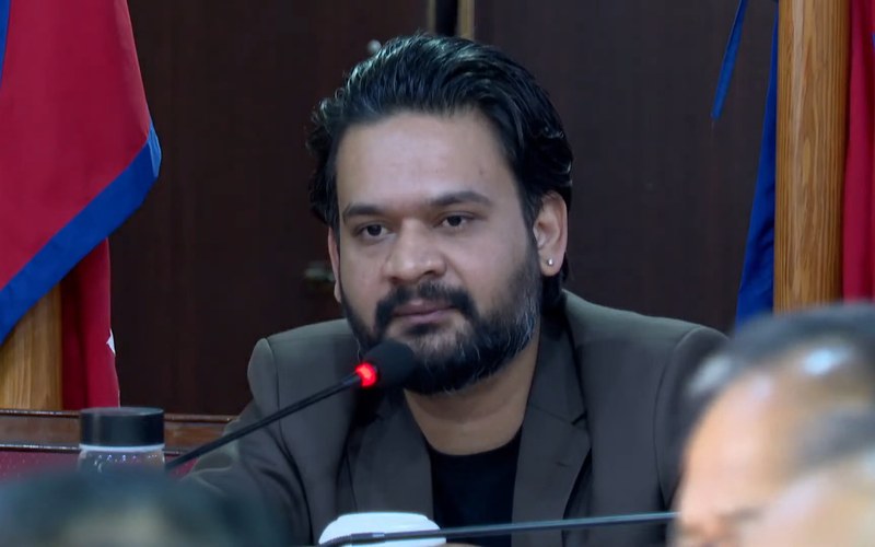 Balendra Shah speaking at a microphone with the Nepal flag behind him. Photo: Metro News / Wikimedia Commons (CC BY 3.0)