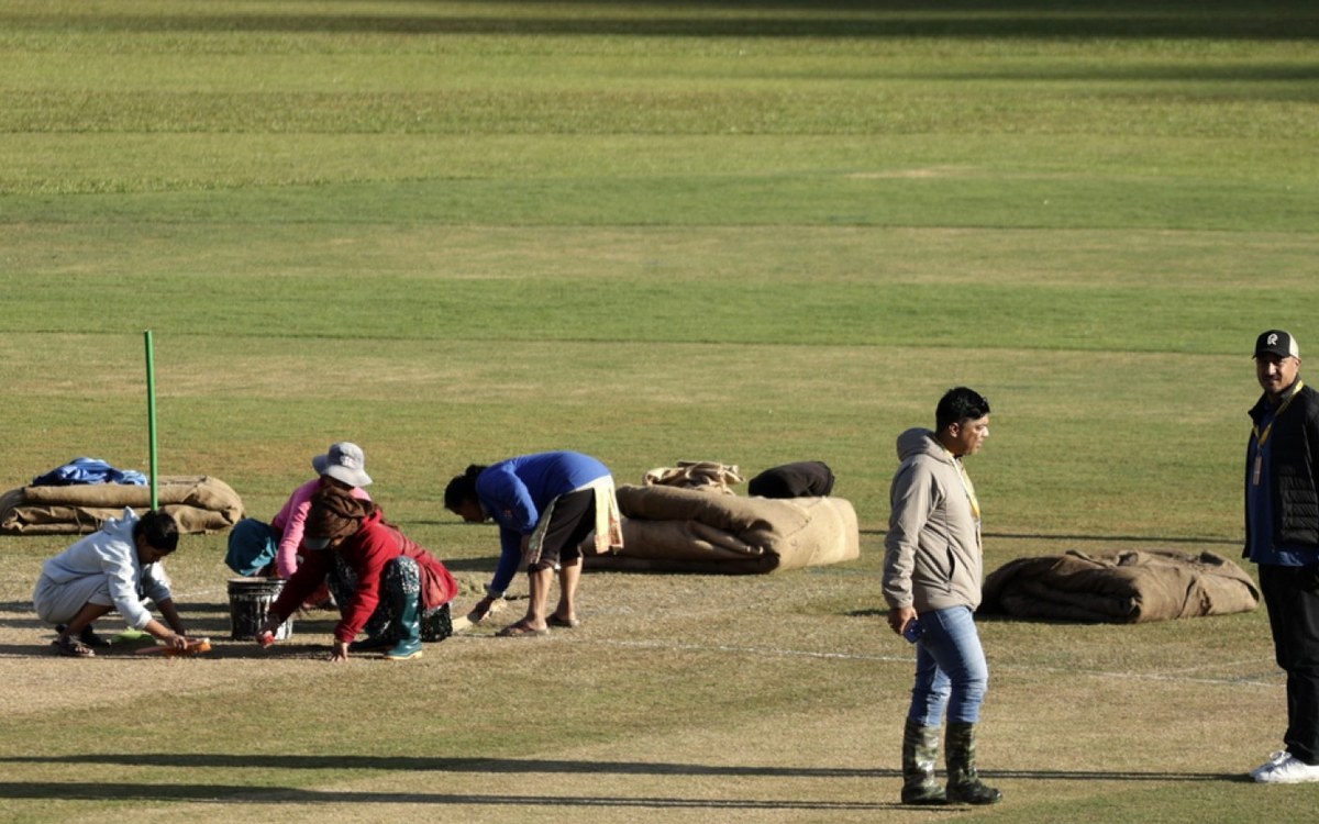 Ground staff working on the pitch at TU Ground in Kirtipur after the covers were removed on Saturday evening